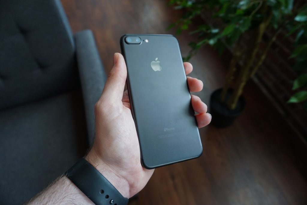 手に持った黒いスマートフォン